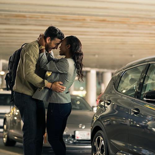Couple reuniting at the pick up lane.